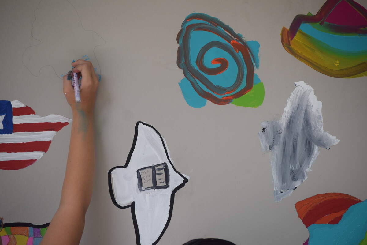 An M.C. Riley Elementary School student paints part of a new mural at Bluffton’s Oscar Frazier Park on Saturday, June 5, 2021.