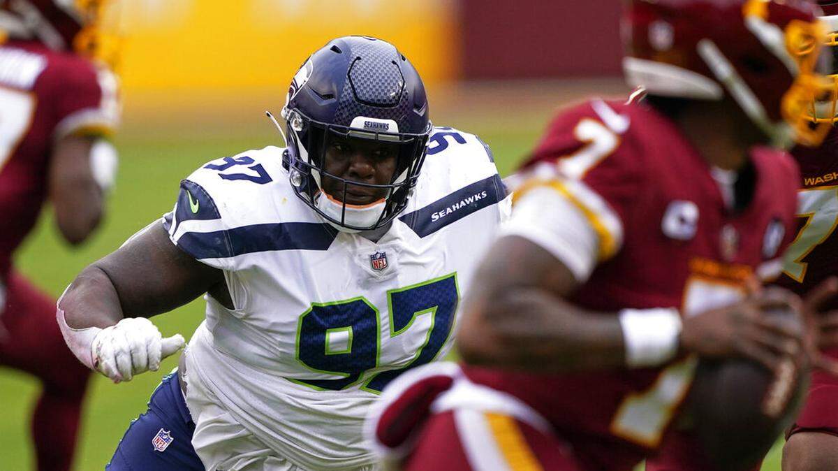 Seattle Seahawks defensive tackle Poona Ford (97) rushes the quarterback during an NFL football game against the Washington Football Team, Sunday, Dec. 20, 2020, in Landover, Md.