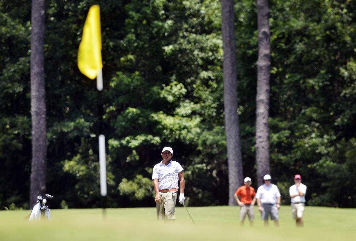 Boys champion Bryson Nimmer, of Bluffton, watches as his ball rolls toward the green of the 17th hole during the final day of the IJGA Junior Open at Chechessee Creek Club on June 19th, 2014.