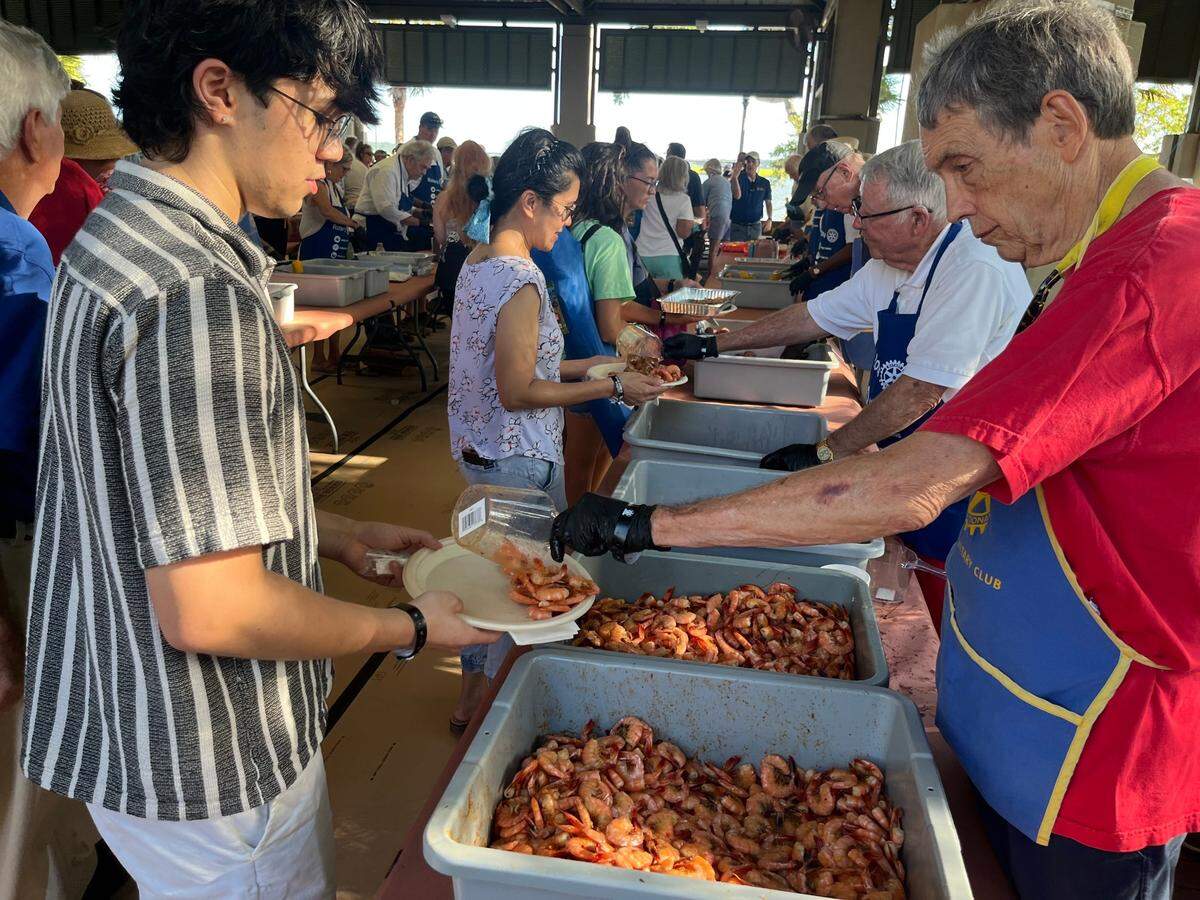 Paul Sommerville serves up shrimp during the Lowcountry Supper, which drew a crowd of about 2,000 Thursday.
