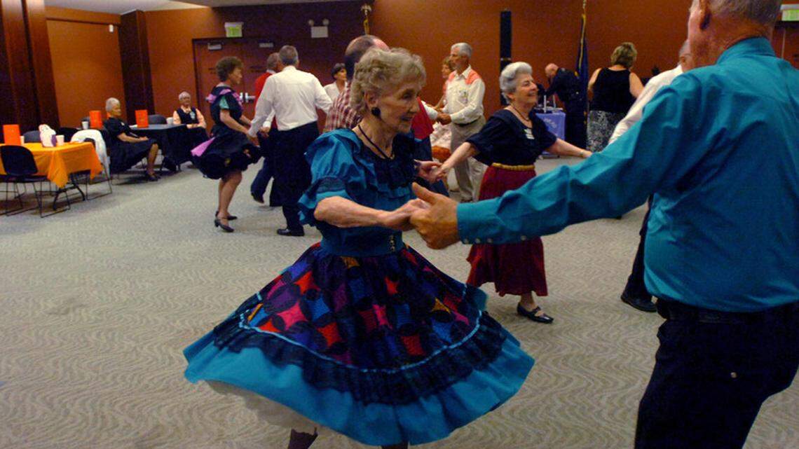 Evelyn Finch, center, dances a turn Saturday night during a club meeting of the Ocean Waves square dance club inside the Palmetto Electric building in Bluffton.