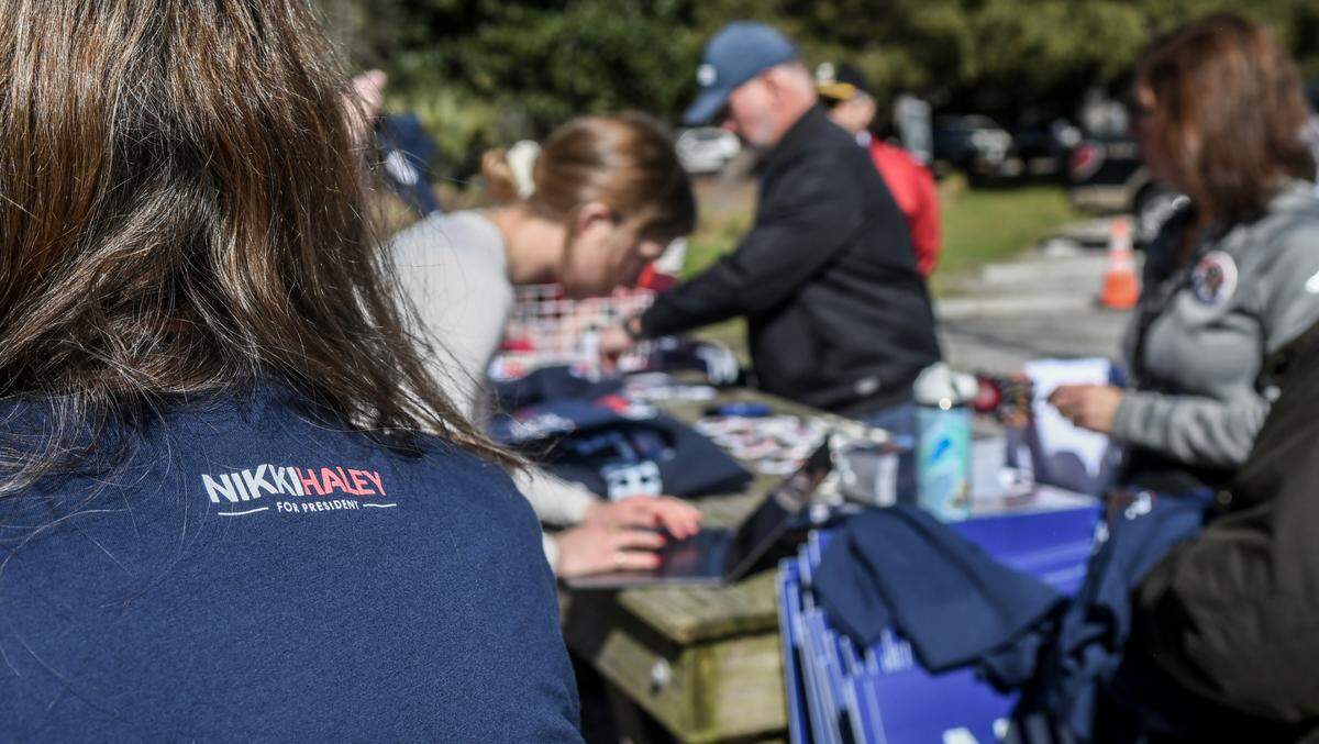 Volunteers with former S.C. Governor and U.S. Ambassador to the United Nations Nikki Haley sells shirts and other political garb at her political bus tour stop as she campaigned for the GOP presidential nominee on Tuesday, Feb. 13, 2024 at Bluffton Oyster Factory Park in Old Town Bluffton.