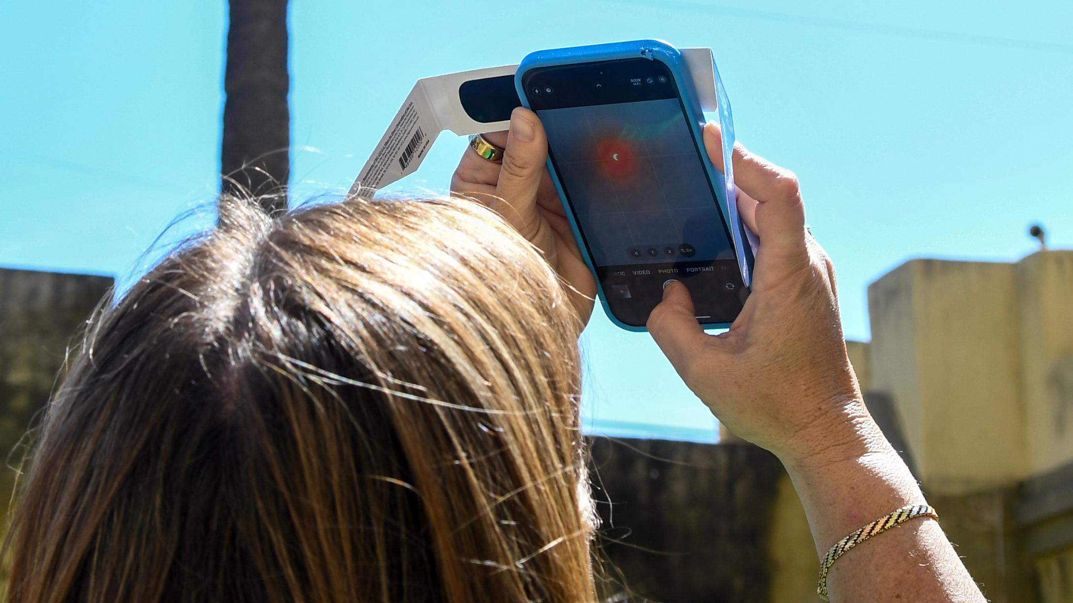 Beaufort locals and visitors watch solar eclipse from courtyard of the historic Arsenal