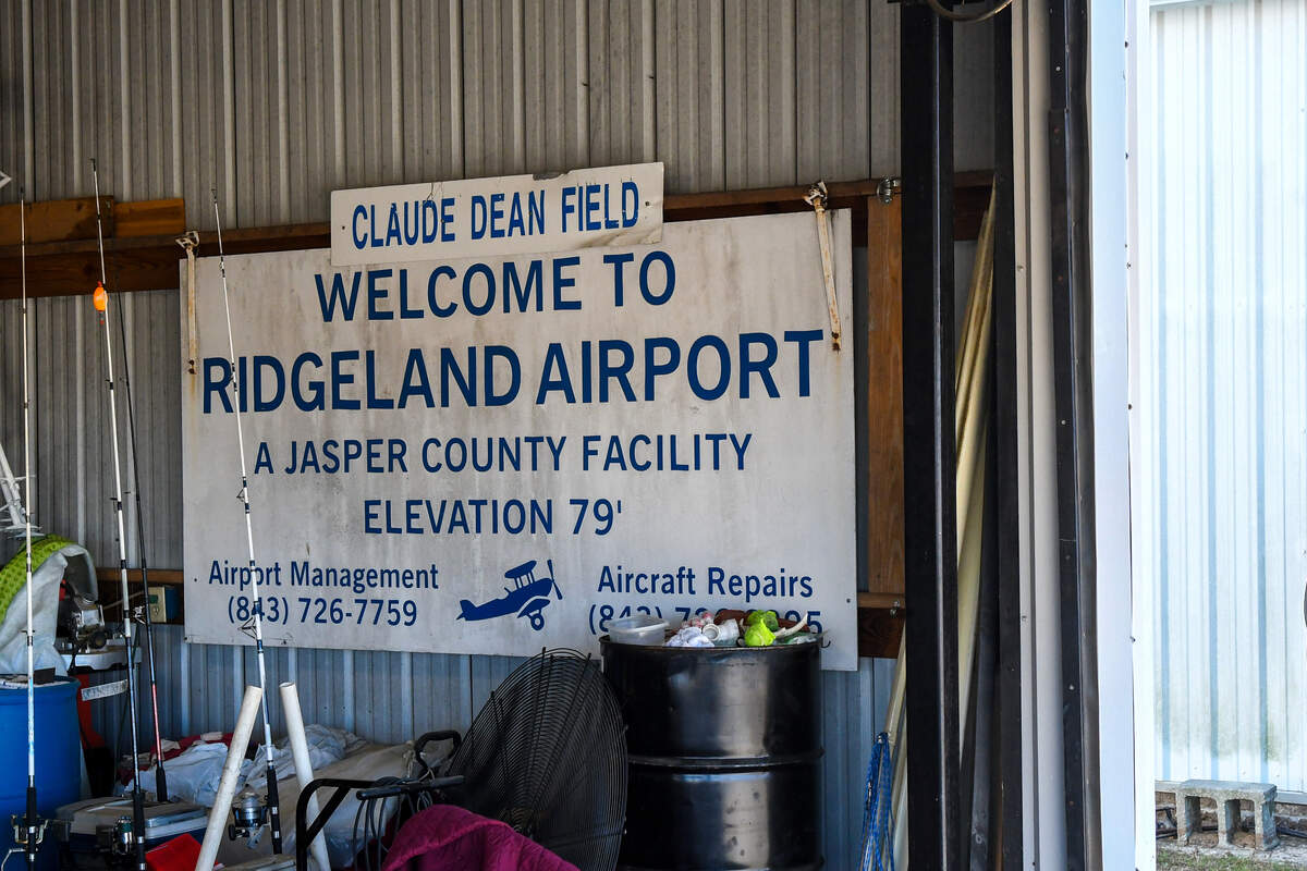 Richard Dean, son of the namesake of the Ridgeland – Claude Dean Airport, has this sign in his hangar that other pilots had re-named Ridgeland Airport the Claude Dean Field because of his father’s work at the Jasper County facility.