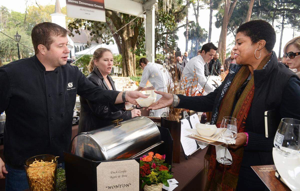 Matt and Carol Jording, left, co-owners of Hilton Head Island’s Sage Room restaurant serve another customer at the Music to Your Mouth food festival in Bluffton in November 2012.