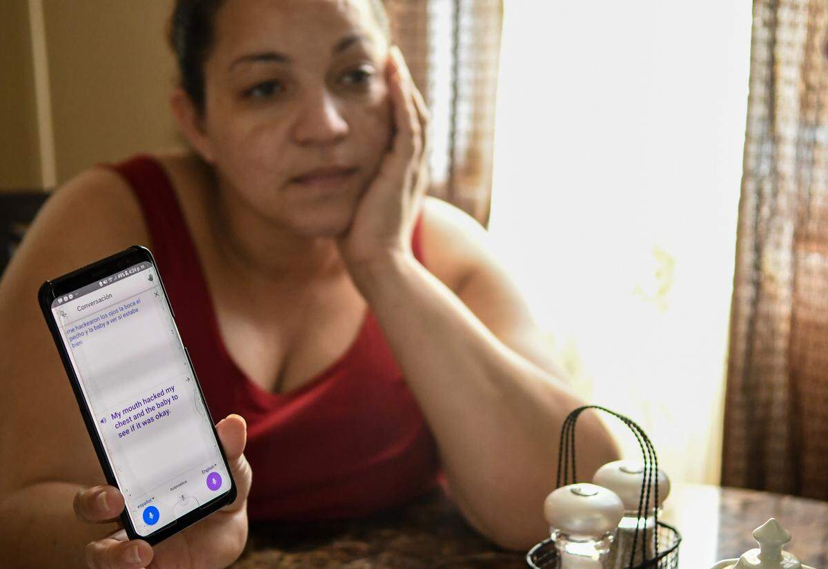 Jenny Valdez uses her smartphone to translate her answers from Spanish to English for reporters questions on Thursday afternoon about the symptoms she was feeling Wednesday night that prompted her trip to Coastal Carolina Hospital. Valdez, who was have breathing problems from the rancid smoke, was mainly concerned for the health of her unborn baby. The home the couple rents is less than 200 feet from Able Contracting’s smoldering Material Recovery Center.