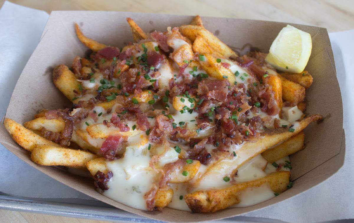 Slapfish’s Chowder Fries are french fries topped with New England clam chowder and bacon.