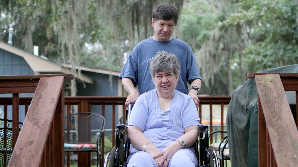 Bill Boulware stands with his wife Kristi for a portrat on the back porch of his mother's house the morning of Sept. 22, 2015, in Port Royal. 