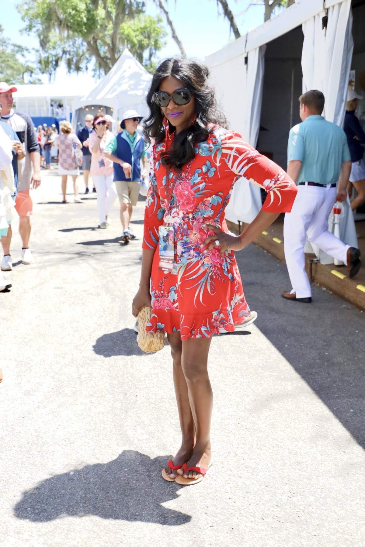 Visiting from Georgetown, SC, Pamela Barber is all sorts of stunning in her vibrant red dress. Her red dress is complemented by her purple-shade lip color and structured woven clutch. Very few can pull off wearing a bright red dress with red accessories, but Pamela definitely can.
