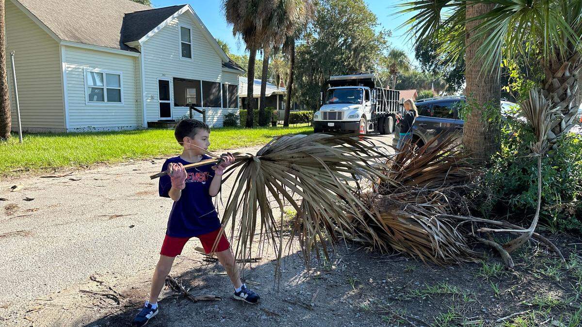 “I did not like that hurricane,” said 8-year-old Harrison McKenzie as he helped pick up nearby palmetto fronds along Alljoy Road, some of which were larger than himself.