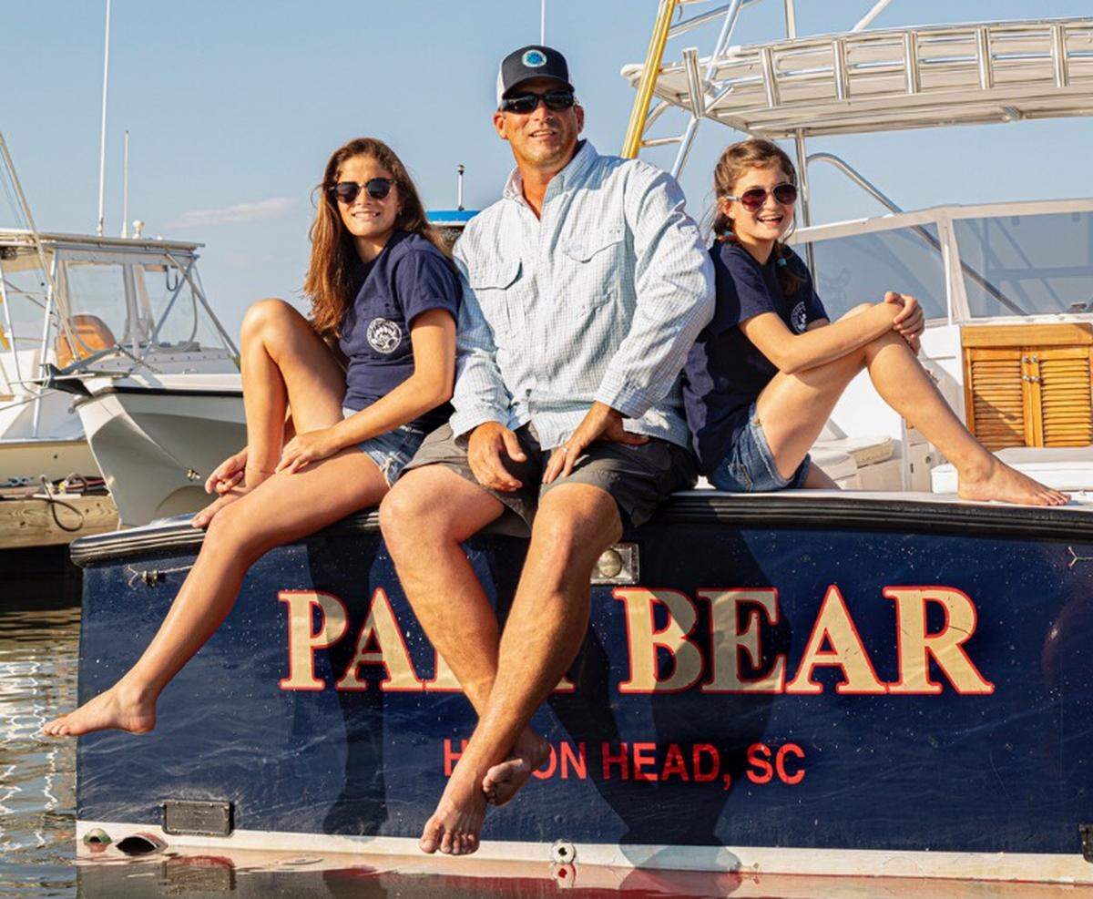 Michael Perry and his two daughters Audrey and Olivia aboard his charter fishing boat, “Papa Bear.”