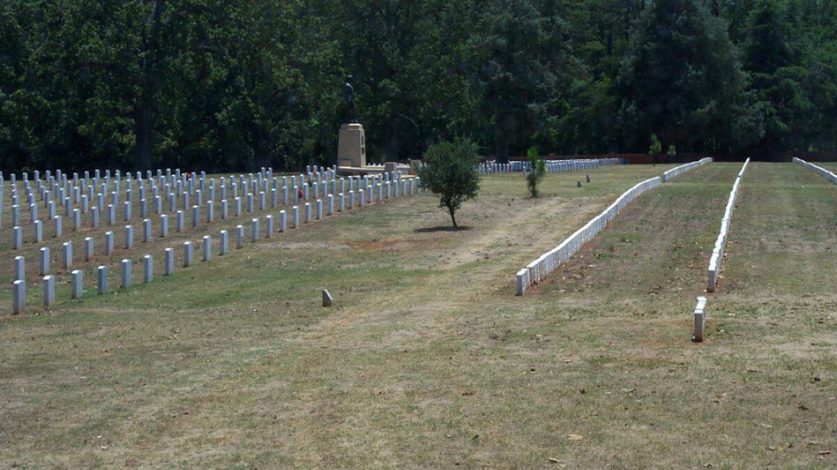 In the Andersonville National Cemetery, a monument representing a state of deceased veterans stands in a section of more than 18,000 interments.
