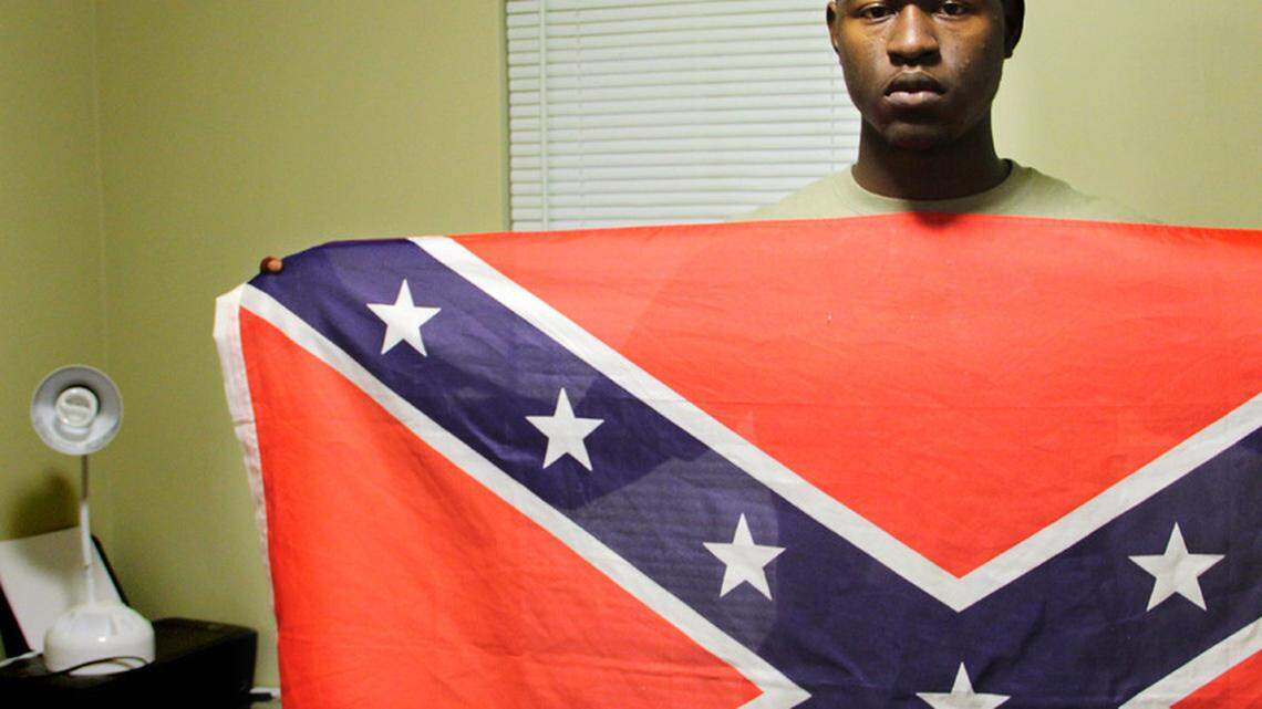 Byron Thomas, then 19 and a student at USCB Beaufort, holds a Confederate Flag in his dormitory room in 2011.