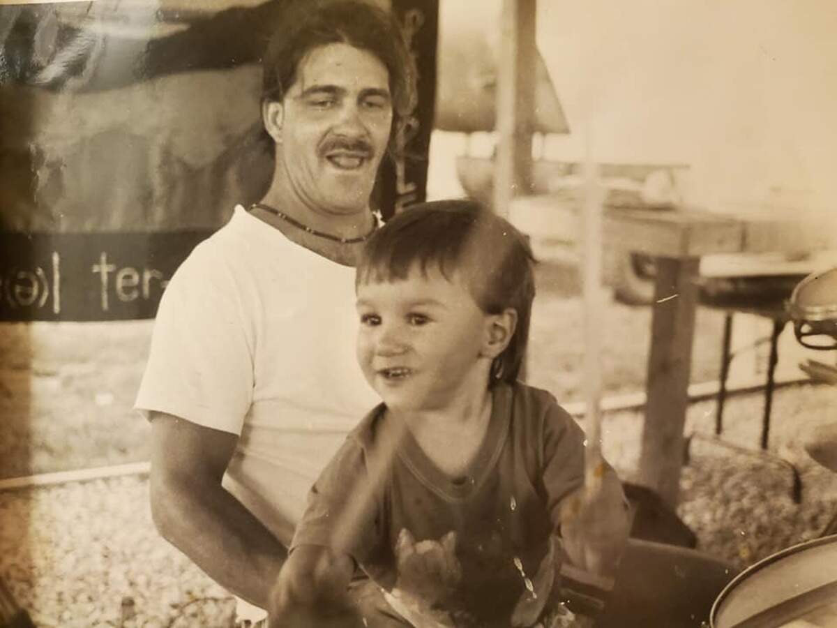 Donny Luciano plays the drums with his son Gabe in front of a backdrop for his band, Steel Pterodactyl, in West Virginia. Donny Luciano died Nov. 3, 2020.