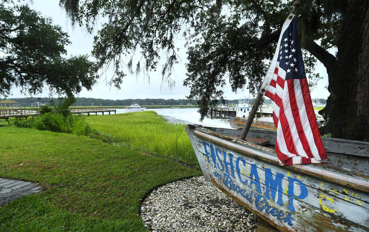 You can watch the boats pass by from beneath the shady oaks at Fishcamp on Broad Creek.