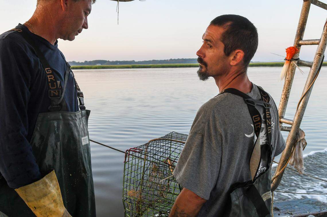 Disappointed with the lack of crabs, Brett Everett, left, and fisherman William Beveridge reassure themselves that Everett’s other traps will likely be more productive on Sept. 20, 2024 in the waterways off St. Helena Island.