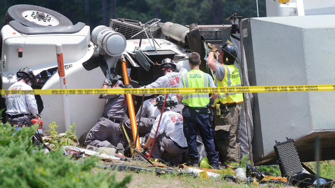 Rescuers work to extricate the driver from the cab of a truck involved in a multi-vehicle collision on June 5, 2014, at US 278 and Buck Island Road. Five people were injured in the wreck.