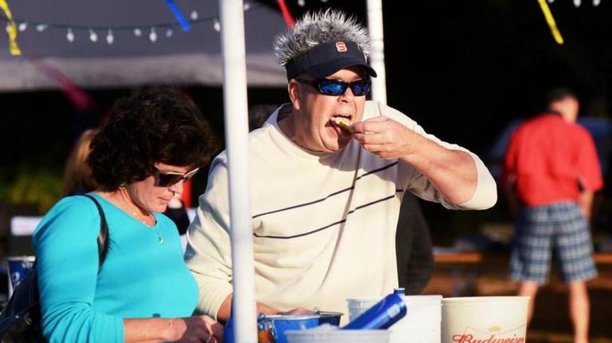 In this 2013 photo Melanie and Tim French, of Bluffton, enjoy the steamed oysters at the Island Recreation Center's Hilton Head Oyster Festival at Shelter Cove Community Park.