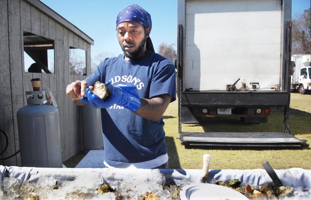 Sandy Clark, of Hudson’s Seafood House on the Docks, keeps his eye on the prize as he cracks open another oyster during the 2015 Hilton Head Island Seafood Fest at Shelter Cove Community Park.