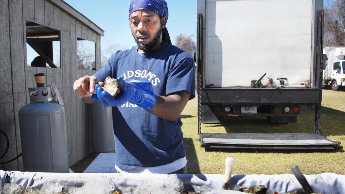 Sandy Clark, of Hudson’s Seafood House on the Docks, keeps his eye on the prize as he cracks open another oyster during the 2015 Hilton Head Island Seafood Fest at Shelter Cove Community Park.