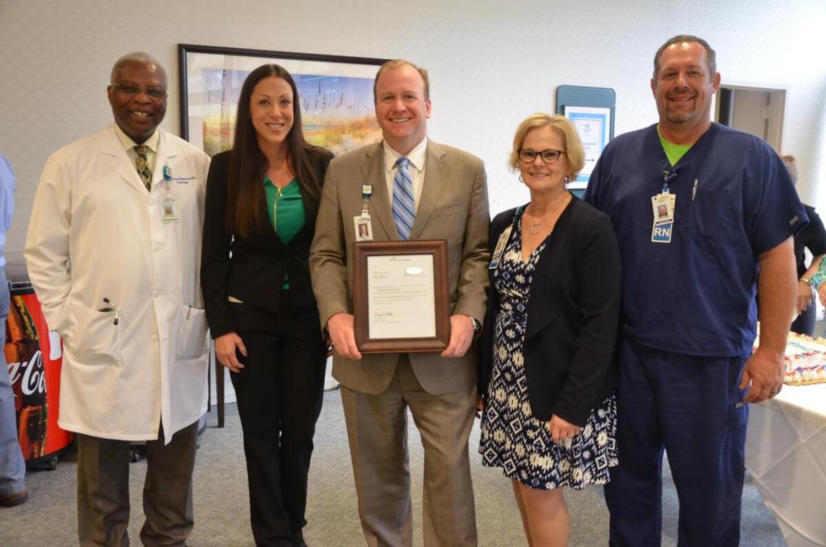 Jeremy Clark, now-former market CEO of Hilton Head Regional Healthcare, center, pictured in 2017.