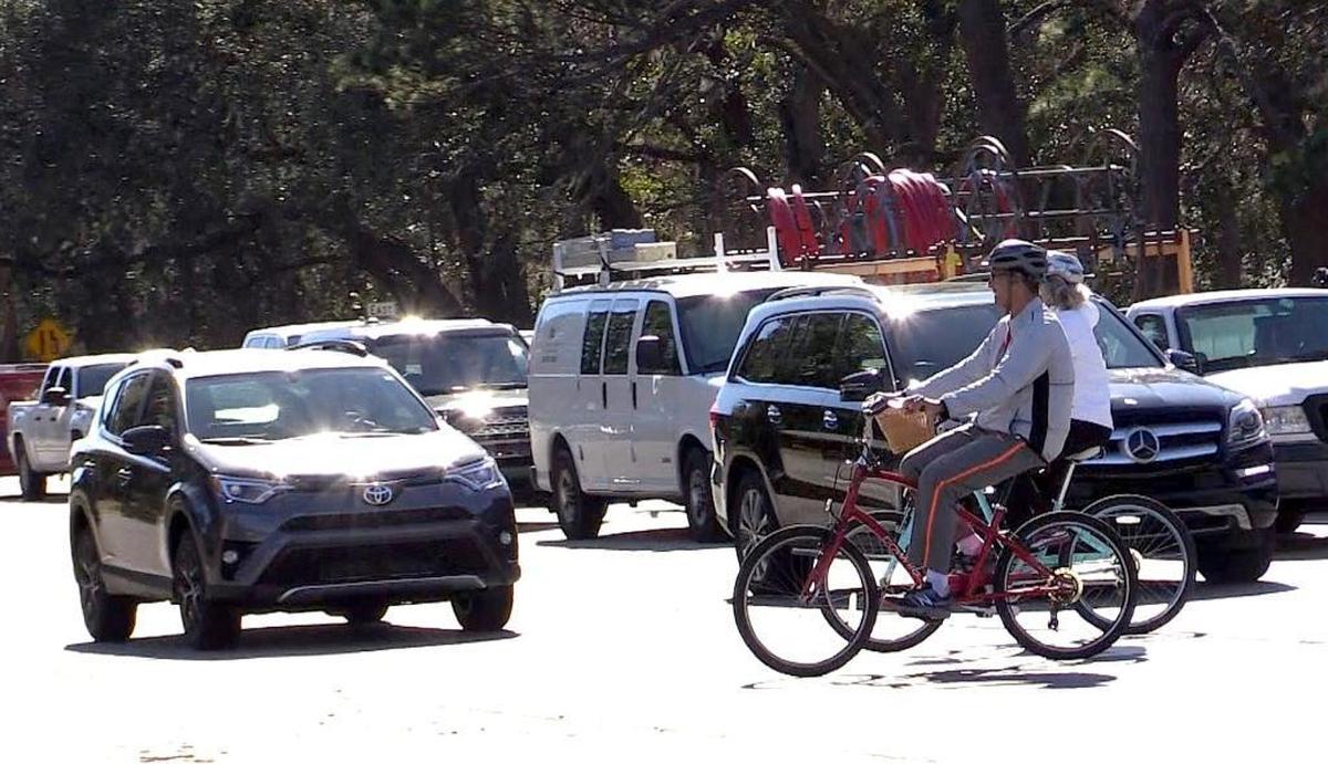 Bicyclists cross U.S. 278 at the intersection of Mathews Drive and Folly Field Road on Hilton Head Island, Jan. 30, 2017.