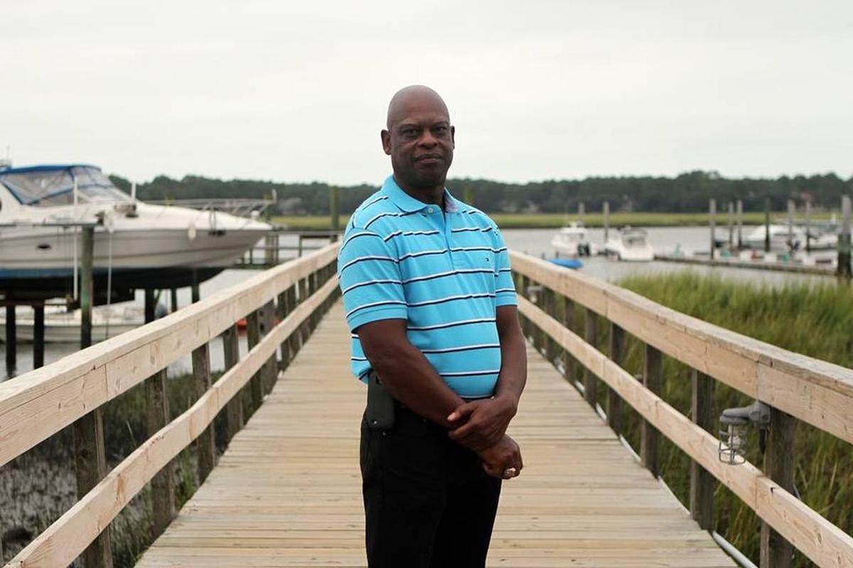 Palmer Simmons stands for a portrait on the dock owned by his family at 11 Simmons Road on September 2015.