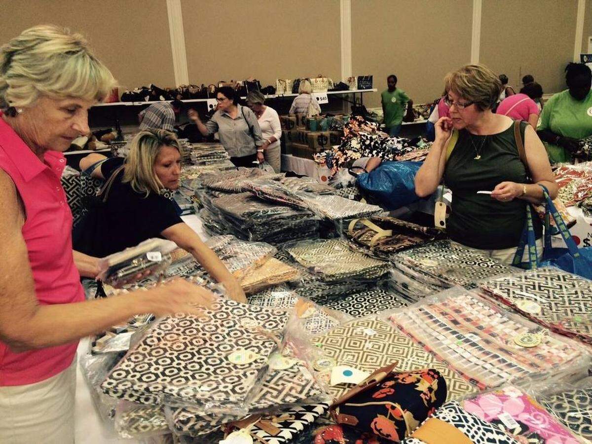 Jill Leveque of Hilton Head (left in pink) shops for market bags at a previous year’s Warehouse Sale.