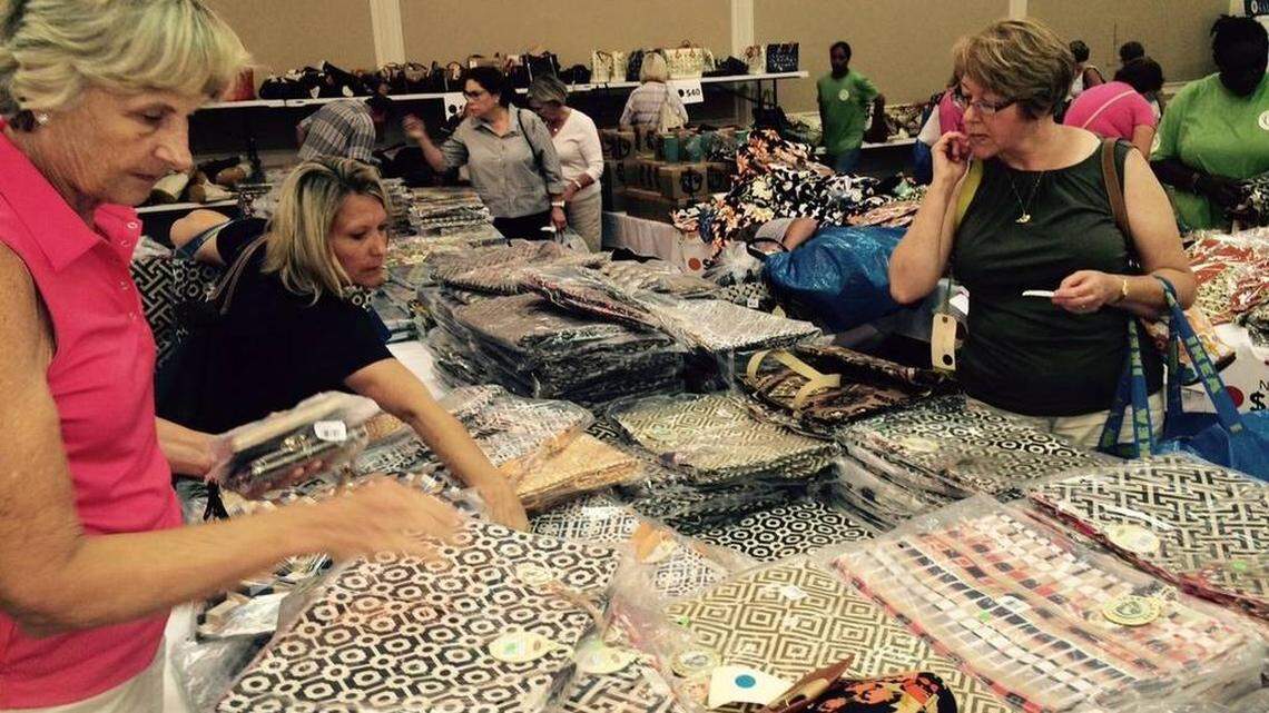 Jill Leveque of Hilton Head (left in pink) shops for market bags Friday at the Spartina 449 warehouse sale in 2015.
