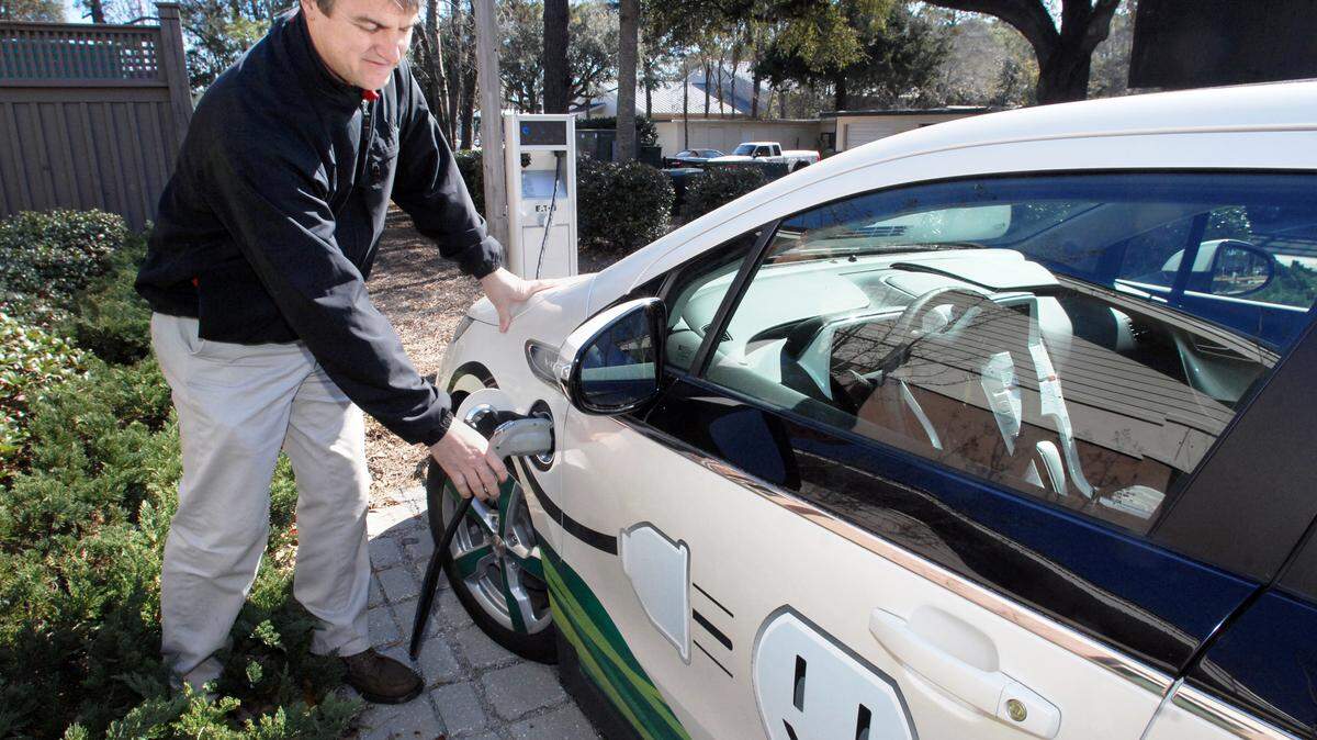 Palmetto Electric marketing manager Parrish Neville shows how the coop’s electrically powered Chevy Volt is plugged into its charging stand at the cooperative’s Hilton Head office. It takes 4-5 hours for the stand to recharge the car’s batteries, he said.