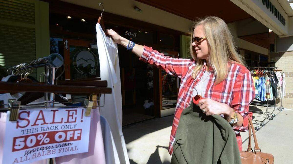 File: Black Friday shopper Amy Jones, of Hilton Head Island, shops for presents at Outside Hilton Head on Nov. 27, 2015. She said she found the sale items appealing. "Fifty percent off, I like to see that for sure," she said.