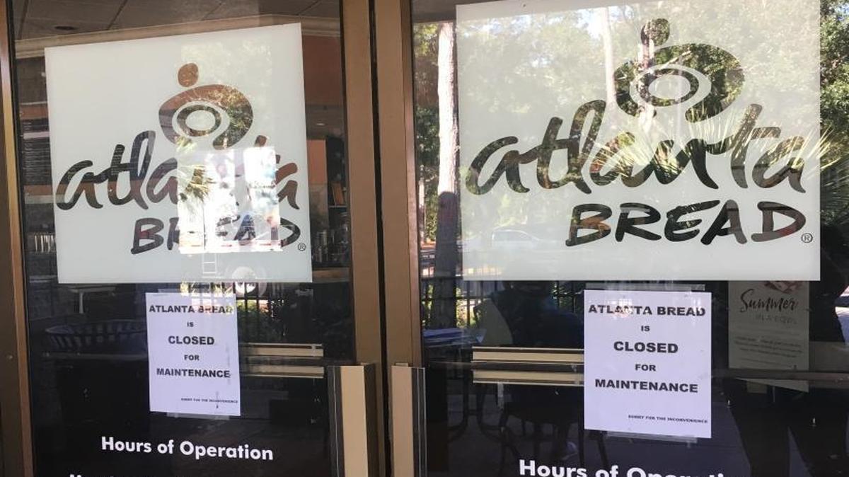 Signs hung on Atlanta Bread Company’s doors Tuesday announcing it would be closed.