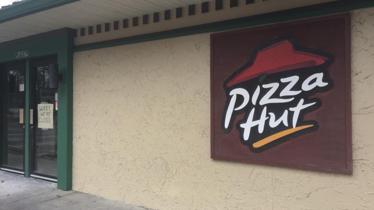 A sign posted to the front door of the Pizza Hut on Hilton Head Island claims the restaurant is closed.