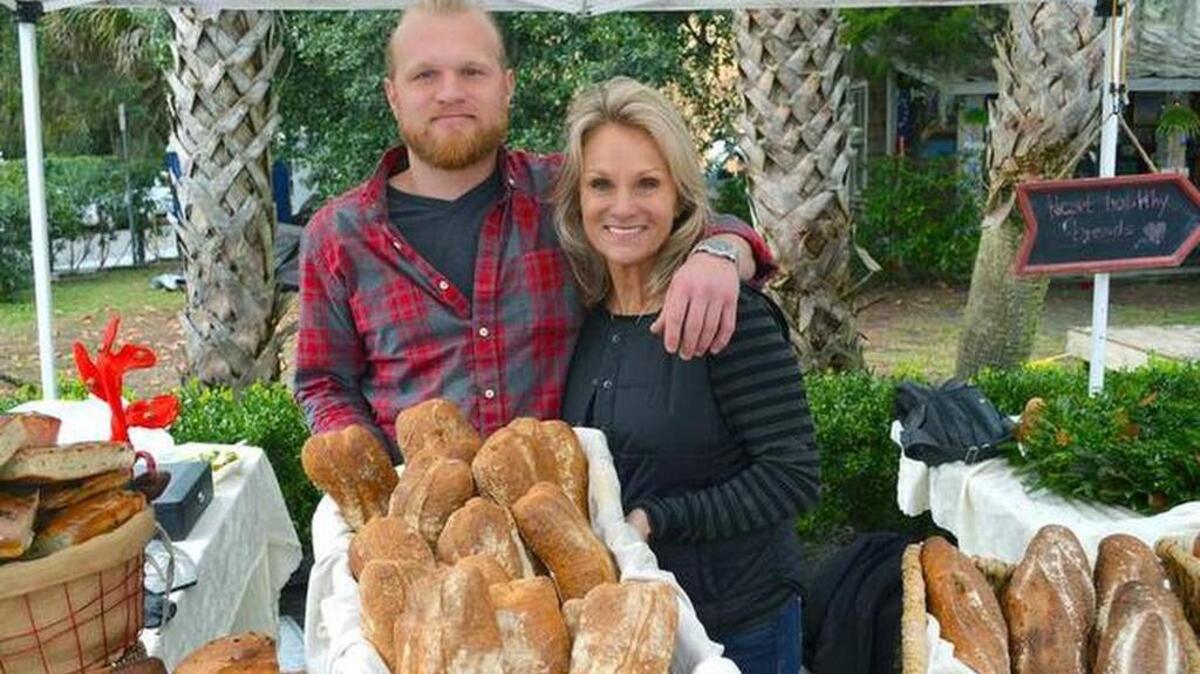 Ryan Fennessey and his mother, Kim Tavino, owners of Sprout Momma Breads on Hilton Head, display some of their baked goods.
