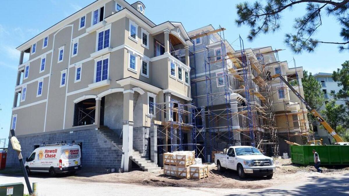 This file photo shows a row of large houses under construction on Bradley Circle near Chaplin Community Park. In the background, at far right, is one of the buildings of the neighboring Marriott Surfwatch complex.