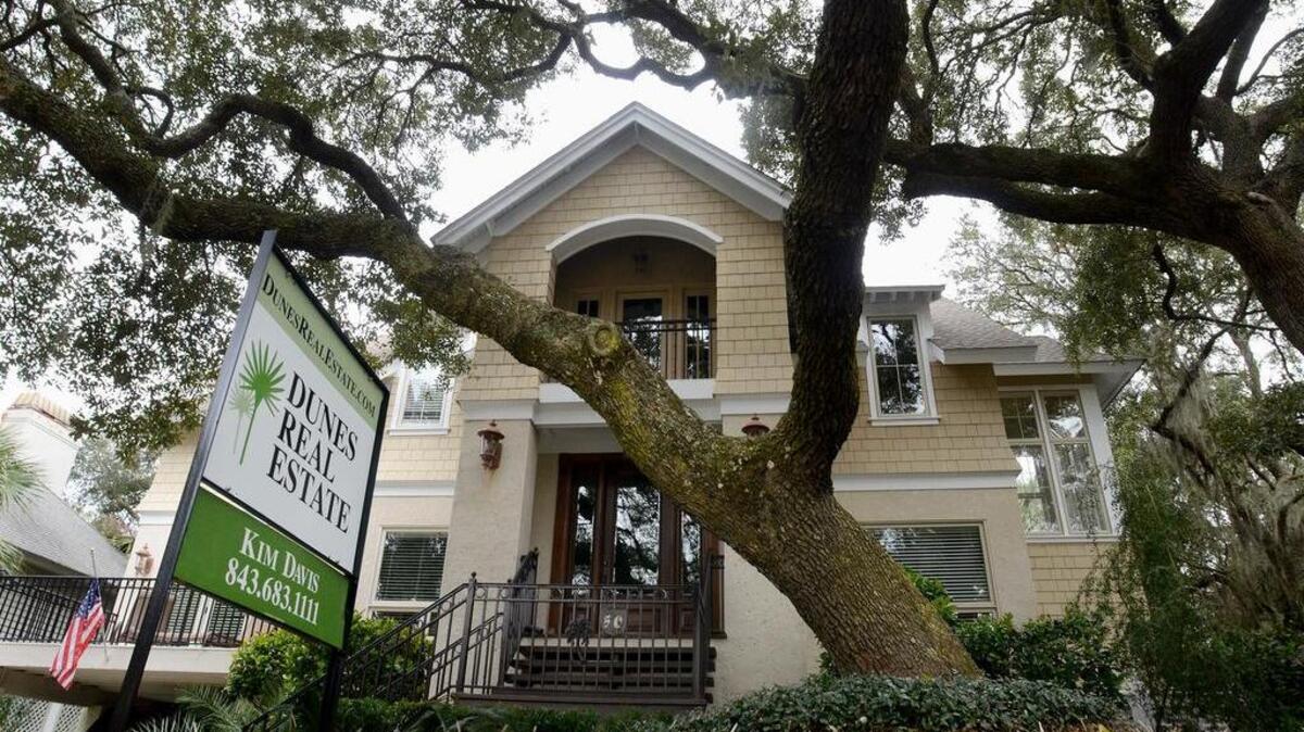 A sign marks a house for sale on Hilton Head's Dune Lane on Monday. The latest sales figures from the 2015 SC Realtors report show improving sales throughout Beaufort County.