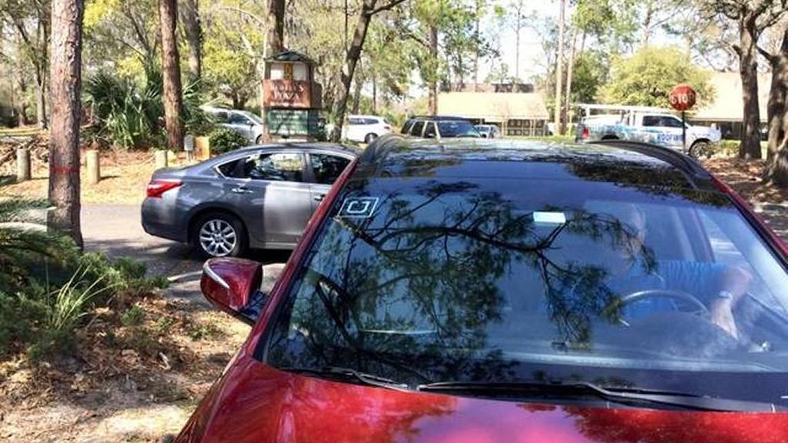 An uber driver sits outside Sea Pines last month following a suspension of the companies services inside the community.