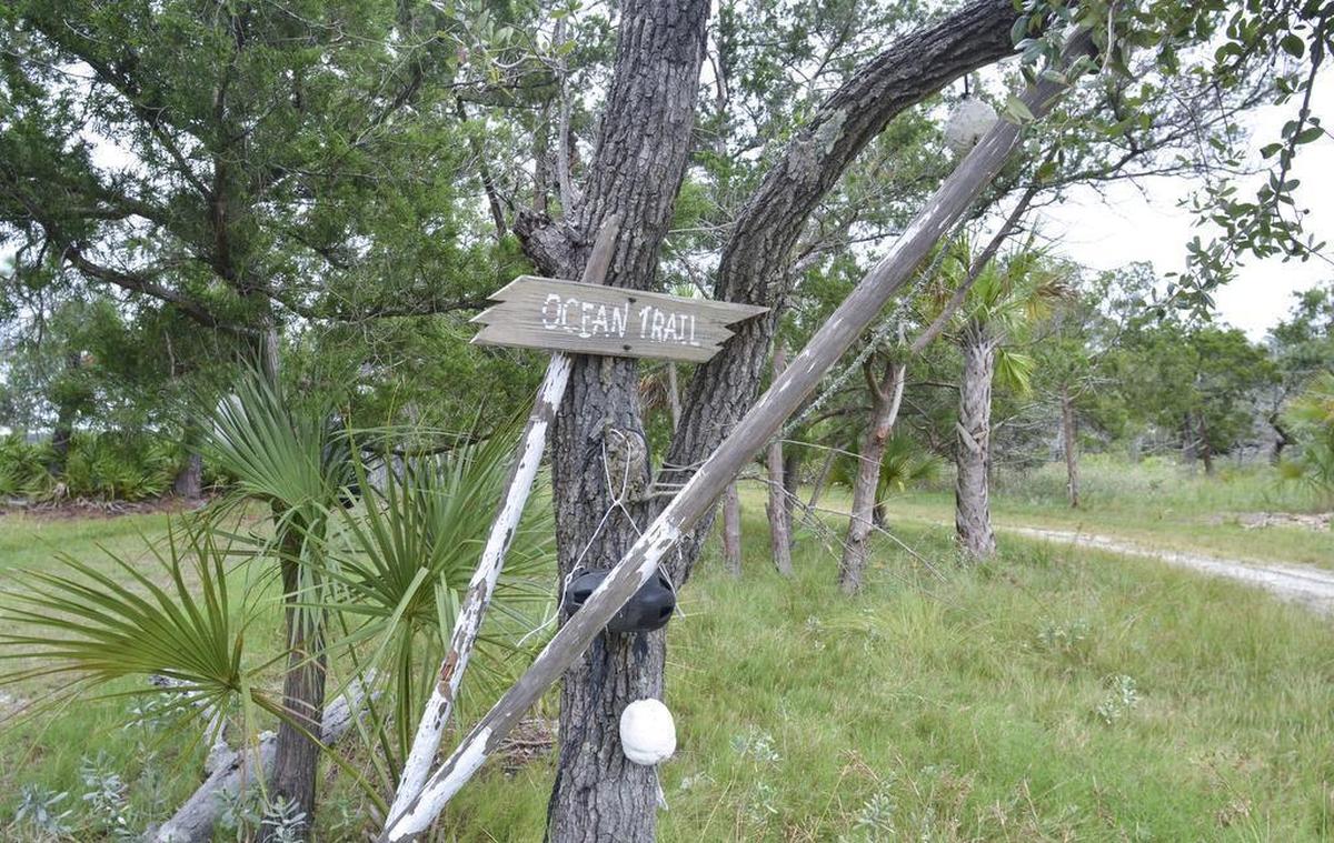 A rustic sign marks one of the trails on Bay Point Island on Sept. 22, 2016.
