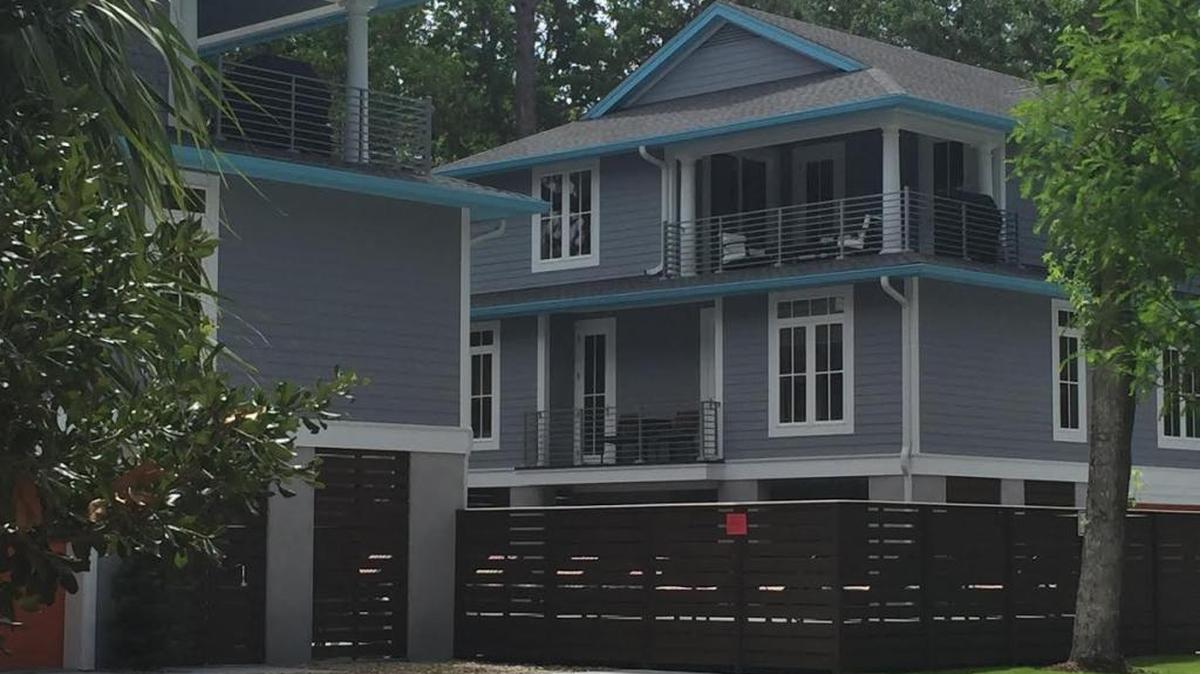 These two Heron Street homes have been the subject of controversy because of a common deck. The town has ruled the properties can function as a single unit, waiving setback and buffer requirements.
