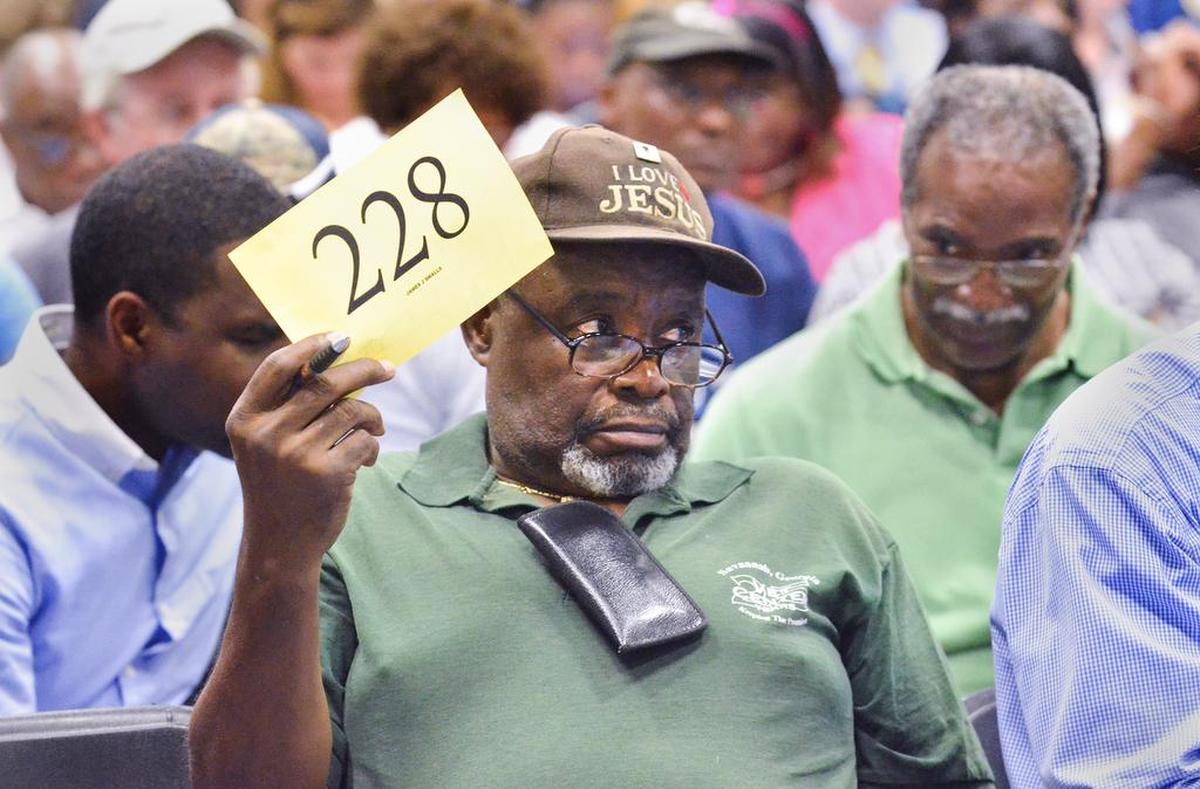James Smalls, of Beaufort, bids on a property up for auction during the Beaufort County Tax Sale on Monday, Oct. 3, 2016 at the Charles Lind Brown gymnasium in Beaufort. The sale of properties whose owners have fallen behind on their taxes is held annually on the first Monday in October.