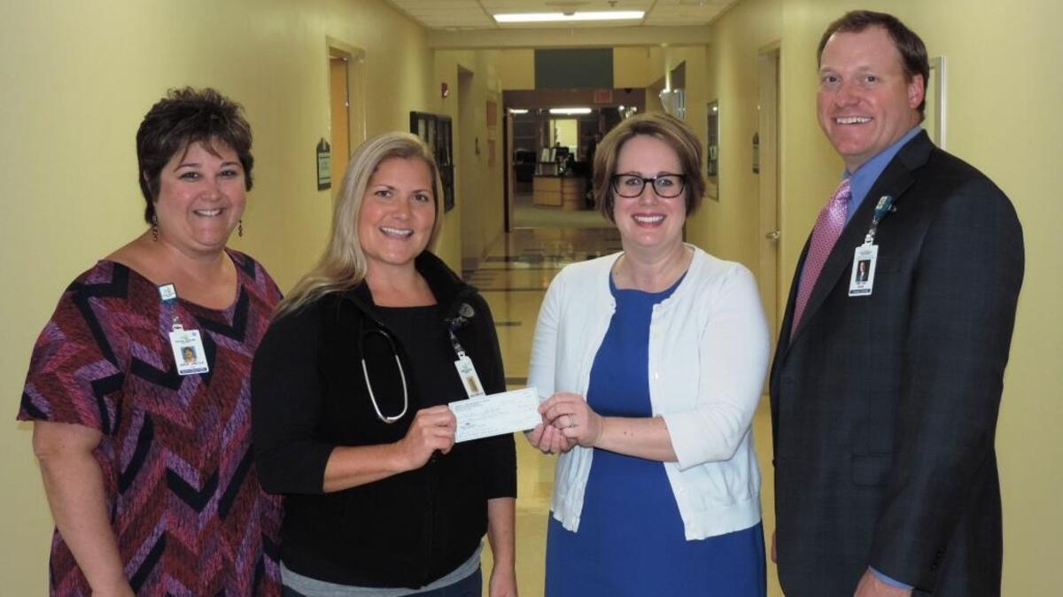Coastal Carolina Hospital director of medical staff services Kristin Cedeno, physician Dr. Molly Gentle, Bluffton Self Help director Alyson Barber, hospital CEO Joel C. Taylor present a $5,000 donation check.