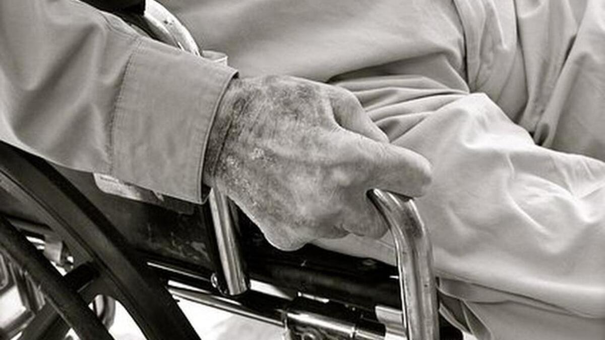 Stock photo of an aging man in a wheelchair.