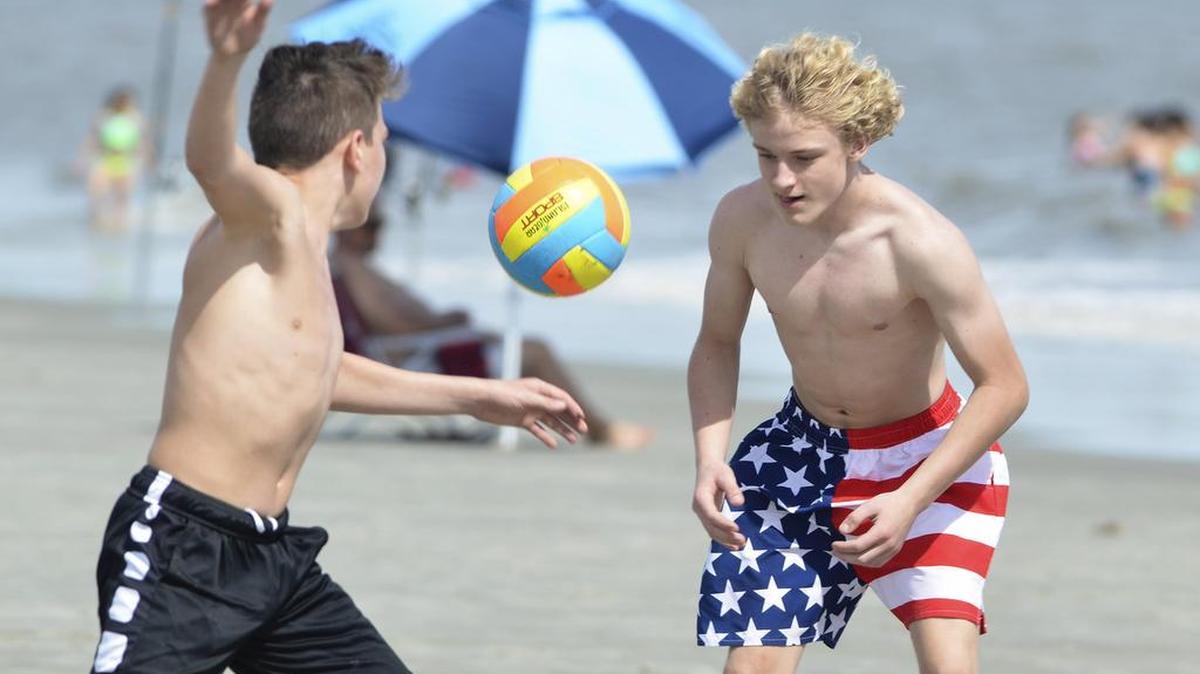 In this file photo from March, friends Andrew Voyles, left, and Nate Butler, visiting Hilton Head Island from Carrolton, Ga., play an improvised game of "two square" at Coligny Beach.