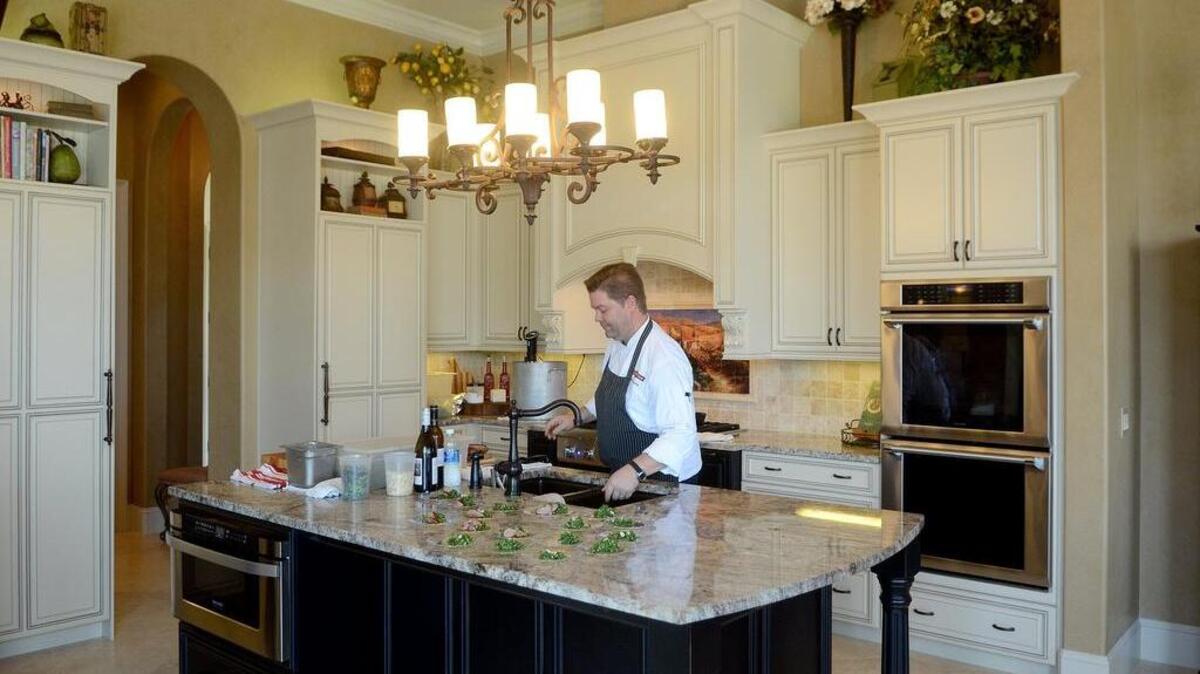 Chef Jeff Congdon, with The Bluffton Room, prepares components of his black coriander duck with kale salad dish on Sunday, Sept. 25, 2016, in the kitchen at the home of Steve and Lisa Marie Temple during the “Kitchen of Note” Tour in Berkeley Hall in Bluffton. All proceeds from the event will be used to support The League of the Hilton Head Symphony Orchestra and Youth Orchestra.