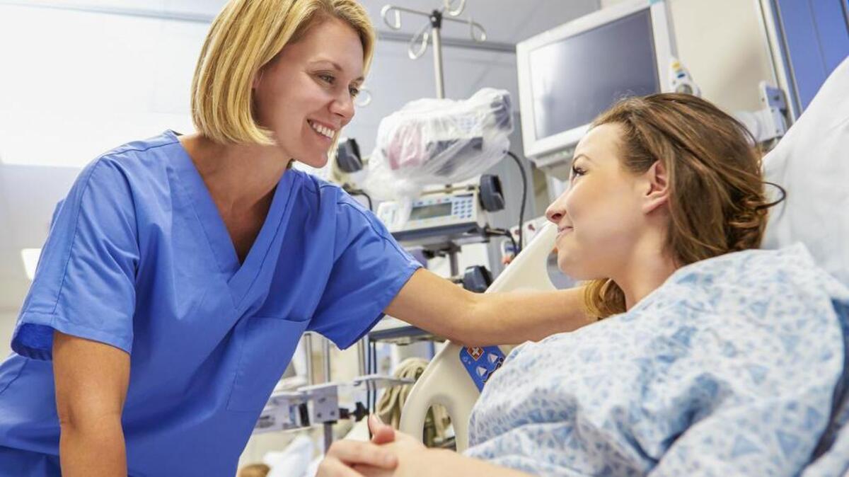 A stock photo of a patient receiving care from a nurse at a hospital.