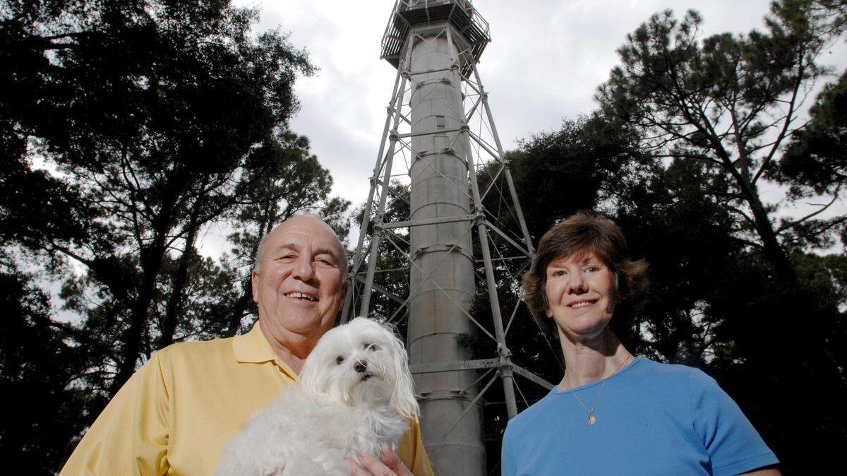 -Larry Green, holding Leamington Lilly, and Kathy Brennan are part of a group of neighborhood residents hoping to raise money — estimated at $100,000 — to restore the decaying Leamington Lighthouse.