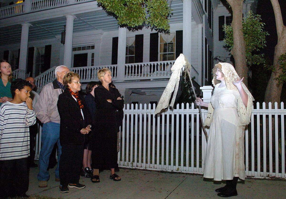 A guide warns guests of frightening times ahead on the Exchange Club Ghost Tour through historic Beaufort.