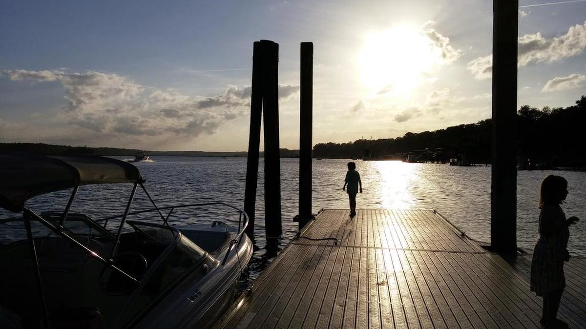 Children play on a Calhoun Street dock at sunset in Bluffton, South Carolina.