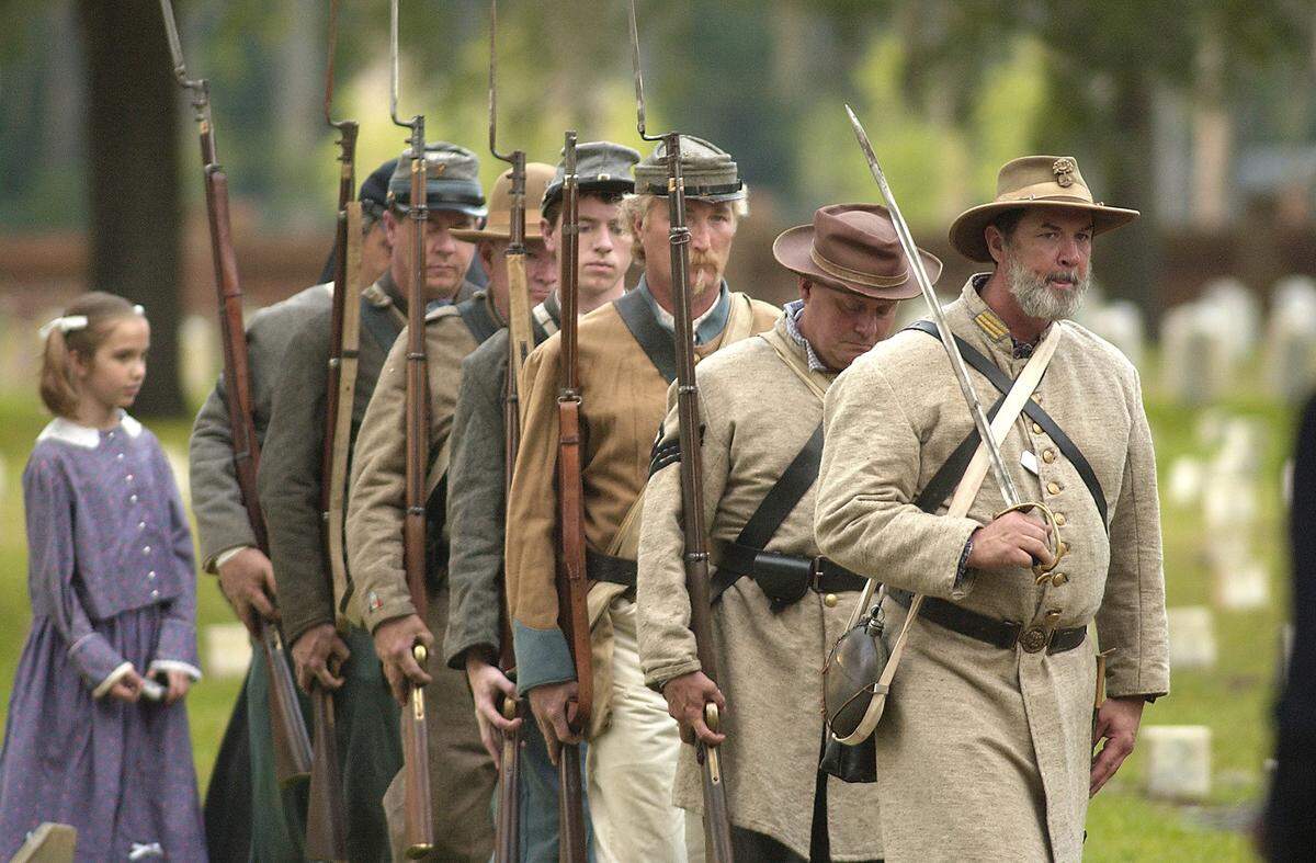 Civil War reenactors from the 11th South Carolina Volunteer Infantry march in formation as they post the colors during Confederate Memorial Day in 2010 at the Beaufort National Cemetery. There are 117 Confederate soldiers buried in the cemetery.