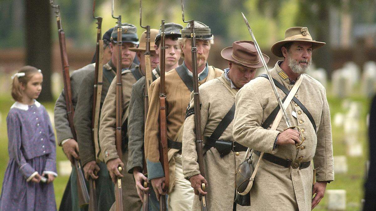 Civil War reenactors from the 11th South Carolina Volunteer Infantry march in formation as they post the colors during Confederate Memorial Day on Monday at the Beaufort National Cemetery. There are 117 Confederate soldiers buried in the cemetery.